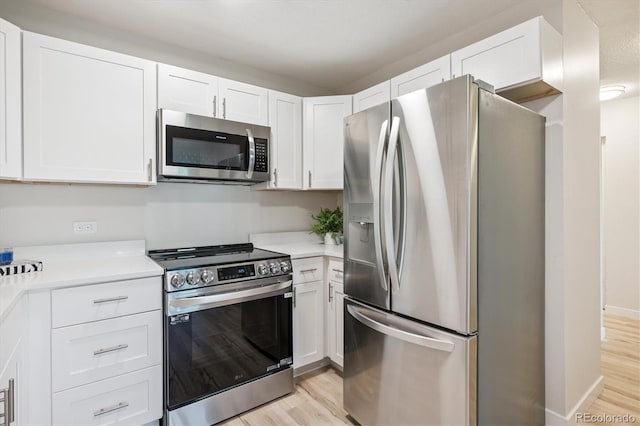 9380 E Center Ave Unit 8A, Denver, CO 80247 - kitchen with appliances with stainless steel finishes, light wood-style floors, and white cabinets
