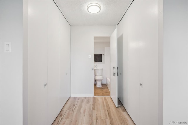 9380 E Center Ave Unit 8A, Denver, CO 80247 - hall featuring light wood-style flooring and a textured ceiling