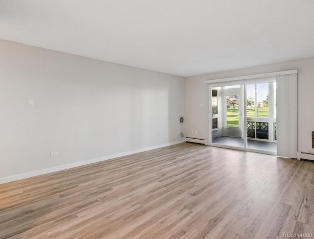 9380 E Center Ave Unit 8A, Denver, CO 80247 - unfurnished room with a baseboard heating unit and light wood finished floors
