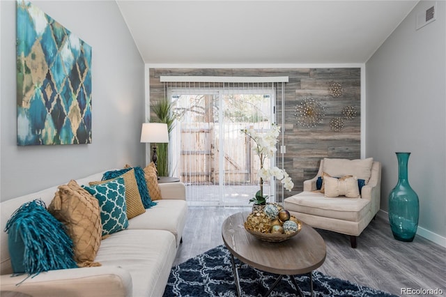 living room with hardwood / wood-style flooring and lofted ceiling