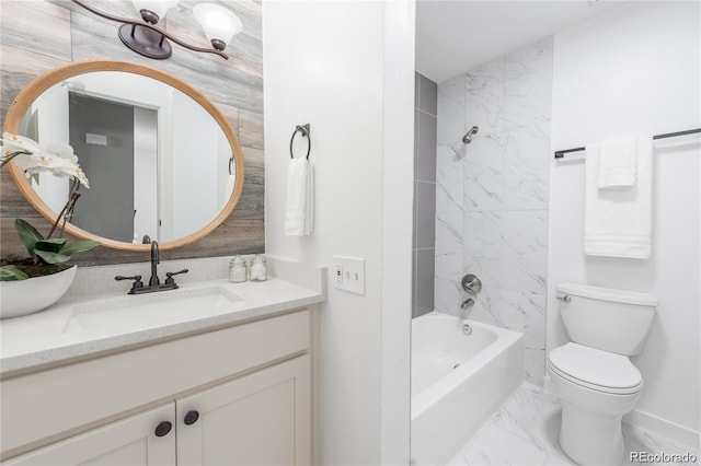 full bathroom featuring tiled shower / bath combo, vanity, and toilet