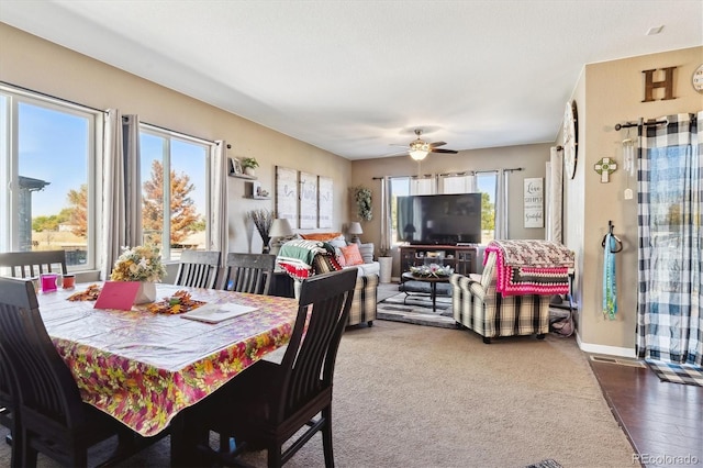 dining area with dark hardwood / wood-style flooring, ceiling fan, and a wealth of natural light