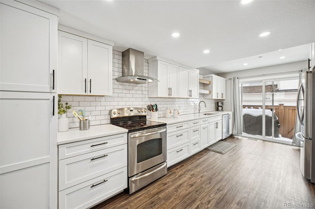 kitchen featuring dark hardwood / wood-style floors, appliances with stainless steel finishes, white cabinetry, sink, and wall chimney exhaust hood