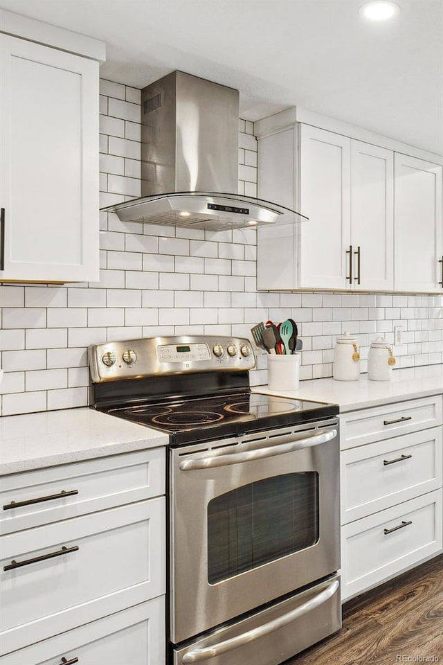 kitchen featuring white cabinetry, wall chimney exhaust hood, and stainless steel electric range oven