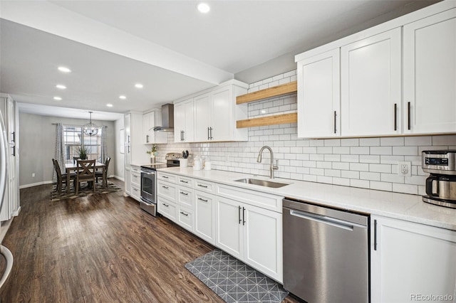 kitchen featuring sink, white cabinets, dark hardwood / wood-style floors, wall chimney range hood, and stainless steel appliances