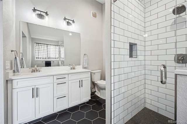 bathroom with vanity, toilet, walk in shower, and tile patterned floors