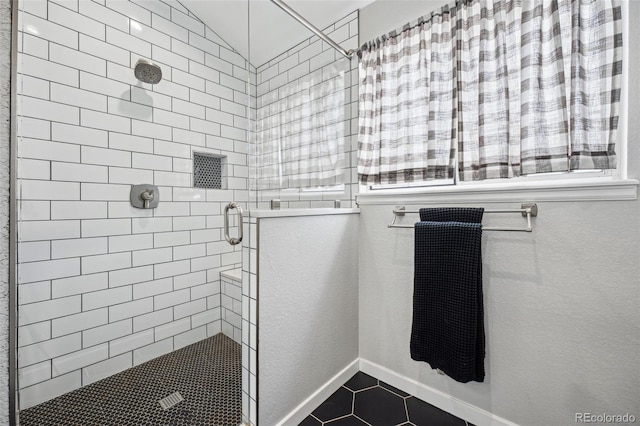 bathroom featuring a shower with shower door and tile patterned flooring