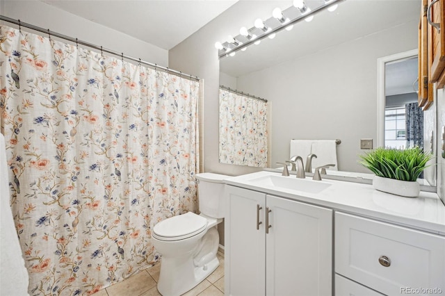 bathroom featuring vanity, toilet, and tile patterned flooring