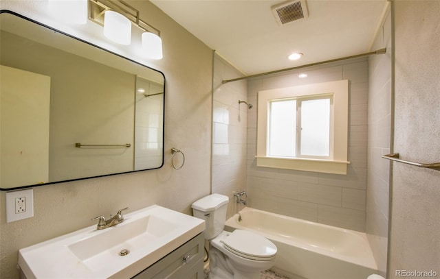 full bathroom with vanity, toilet, and tiled shower / bath