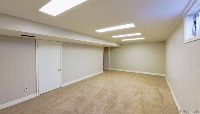 basement featuring light carpet