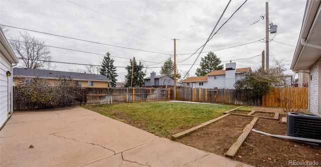 view of yard featuring cooling unit and a patio