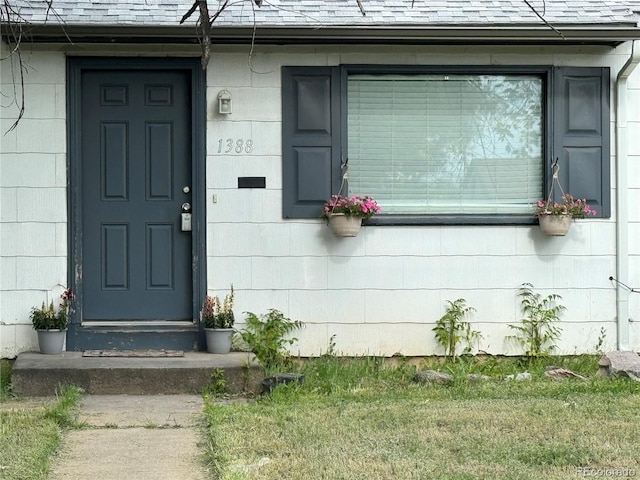 property entrance with roof with shingles