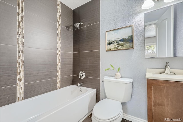 bathroom featuring toilet, a textured wall, bathtub / shower combination, and vanity