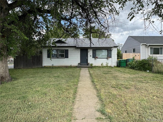 view of front of property with fence and a front lawn