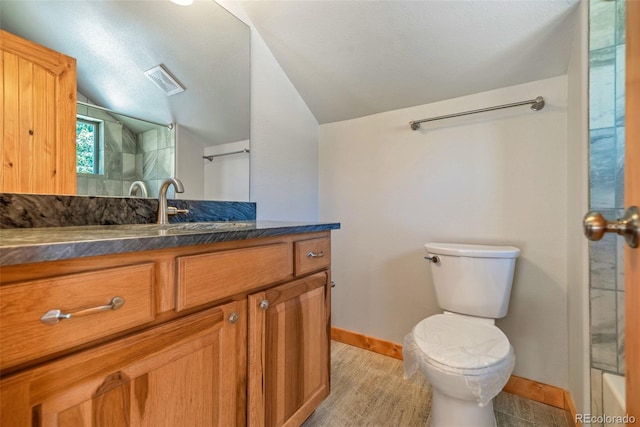 1840 Ute Trl, Como, CO 80432 - bathroom featuring lofted ceiling, toilet, vanity, baseboards, and a shower