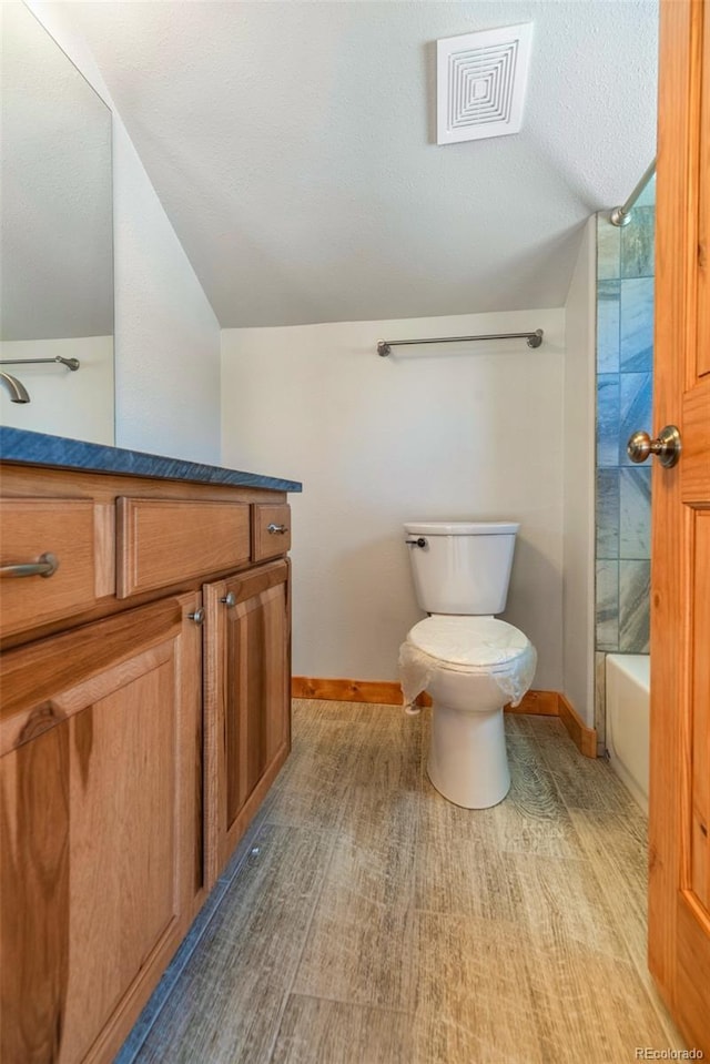 1840 Ute Trl, Como, CO 80432 - bathroom with vaulted ceiling, vanity, toilet, baseboards, and bathtub / shower combination