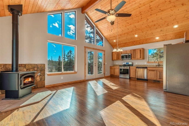 1840 Ute Trl, Como, CO 80432 - living room with high vaulted ceiling, wooden ceiling with exposed beams, wood-type flooring, a ceiling fan, and a wood stove