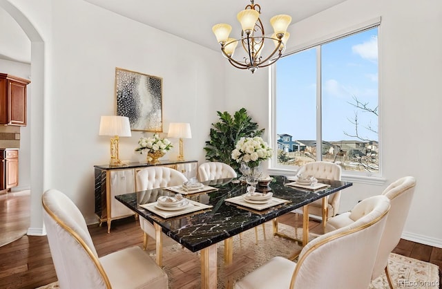 dining space with a chandelier and wood-type flooring