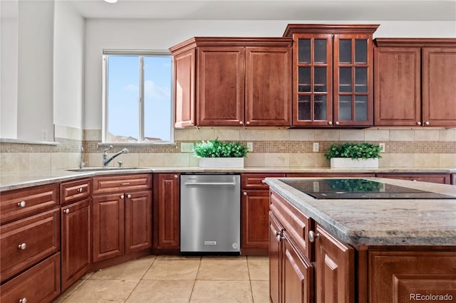 kitchen with light tile patterned floors, black electric cooktop, tasteful backsplash, and sink