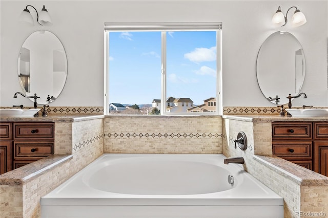 bathroom with a tub and vanity