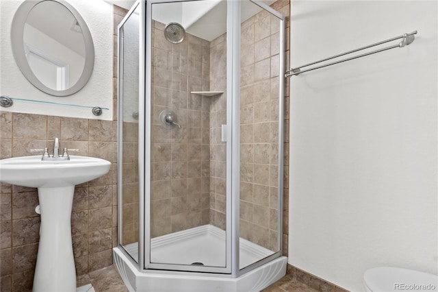 bathroom featuring walk in shower and sink