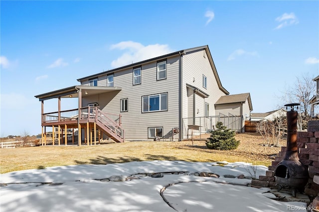 rear view of house featuring a yard and a deck