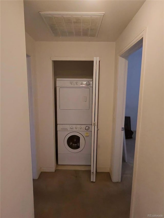 laundry room featuring laundry area, stacked washer / dryer, and visible vents