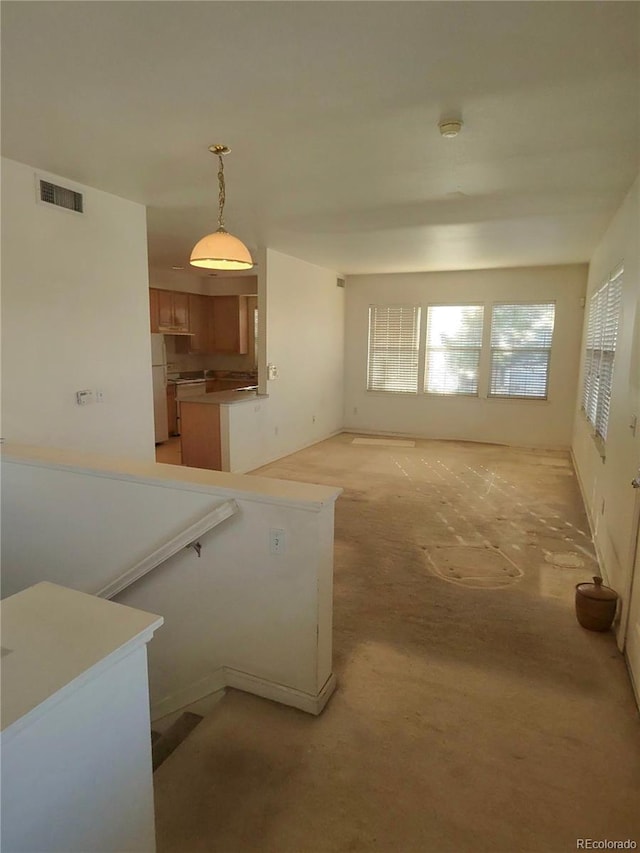 unfurnished living room featuring visible vents