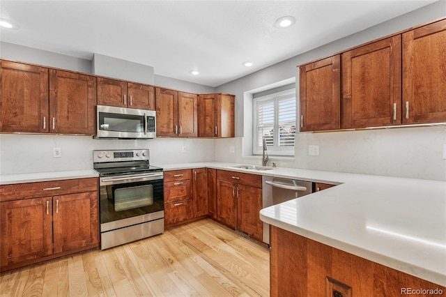 kitchen with sink, light hardwood / wood-style flooring, and stainless steel appliances