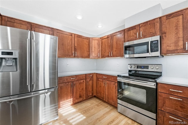 kitchen featuring stainless steel appliances and light wood-type flooring