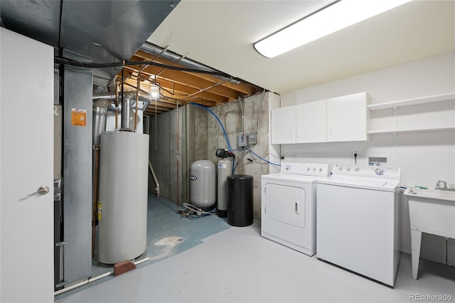 clothes washing area with cabinets, separate washer and dryer, and water heater