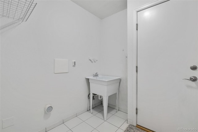 laundry area with light tile patterned floors