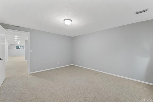 carpeted empty room with a textured ceiling