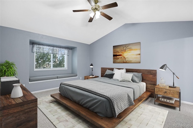 carpeted bedroom with baseboards, lofted ceiling, and a ceiling fan