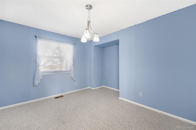 carpeted empty room with visible vents and baseboards