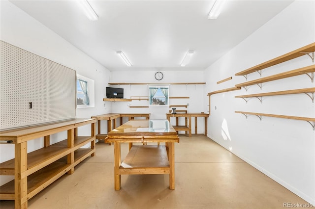 dining room with a workshop area and concrete flooring