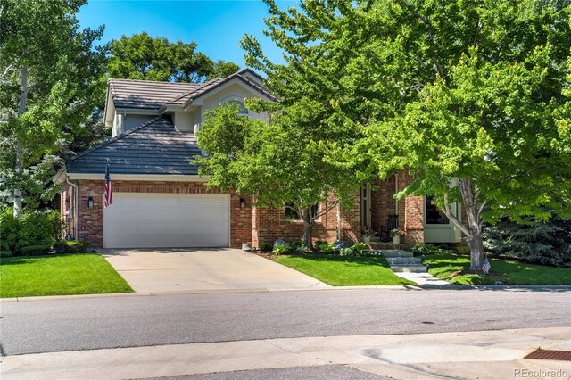 74 Blue Heron Dr, Greenwood Village, CO 80121 - view of front of home with concrete driveway, brick siding, and a front lawn
