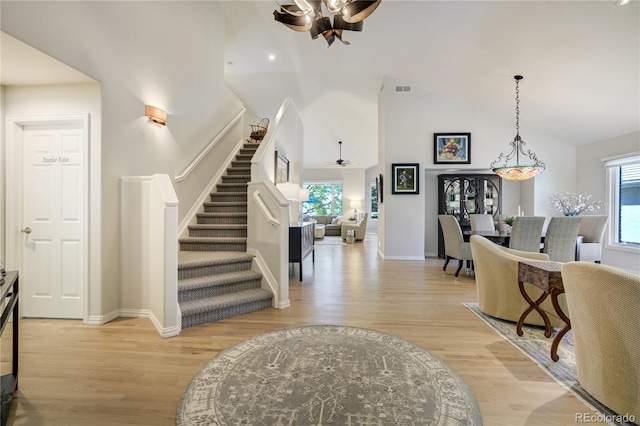 74 Blue Heron Dr, Greenwood Village, CO 80121 - foyer with a ceiling fan, light wood-style flooring, high vaulted ceiling, stairway, and plenty of natural light