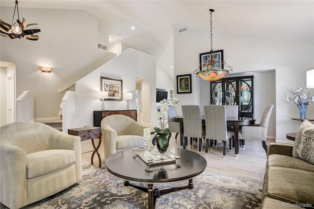 74 Blue Heron Dr, Greenwood Village, CO 80121 - living room featuring high vaulted ceiling, stairs, and wood finished floors