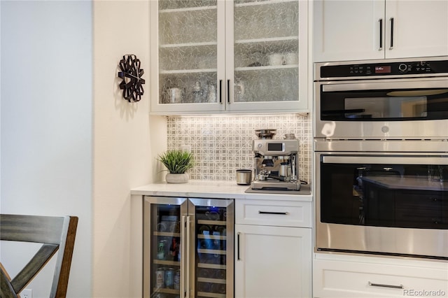 74 Blue Heron Dr, Greenwood Village, CO 80121 - bar with double oven, beverage cooler, and decorative backsplash