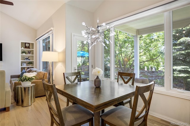 74 Blue Heron Dr, Greenwood Village, CO 80121 - dining area with plenty of natural light, light wood-type flooring, a chandelier, and vaulted ceiling