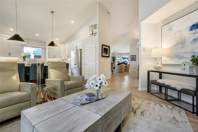 74 Blue Heron Dr, Greenwood Village, CO 80121 - living room featuring light wood finished floors, healthy amount of natural light, recessed lighting, and high vaulted ceiling