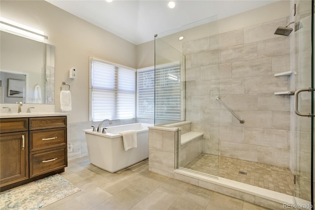 74 Blue Heron Dr, Greenwood Village, CO 80121 - full bath with a freestanding tub, vanity, a stall shower, tile walls, and recessed lighting