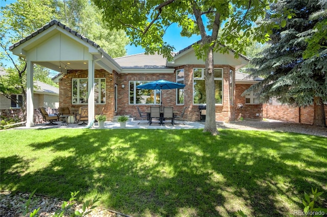 74 Blue Heron Dr, Greenwood Village, CO 80121 - back of property featuring a patio area, brick siding, a lawn, ceiling fan, and a tile roof