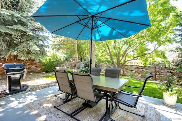 74 Blue Heron Dr, Greenwood Village, CO 80121 - fenced backyard featuring outdoor dining area, grilling area, and a patio area