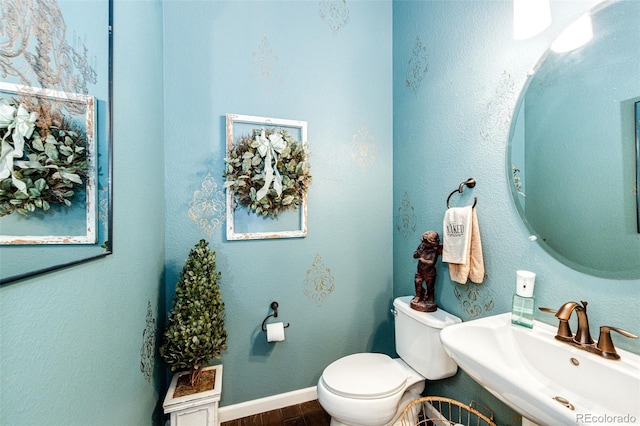 2115 Holmby Ct, Castle Rock, CO 80104 - half bathroom with a sink, wood finished floors, toilet, and baseboards