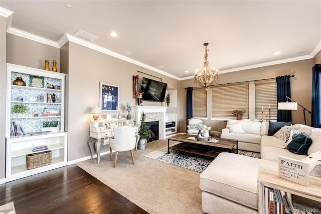 2115 Holmby Ct, Castle Rock, CO 80104 - living area featuring wood finished floors, a chandelier, ornamental molding, a glass covered fireplace, and recessed lighting