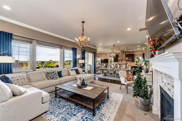 2115 Holmby Ct, Castle Rock, CO 80104 - living room with a fireplace, a chandelier, ornamental molding, healthy amount of natural light, and recessed lighting
