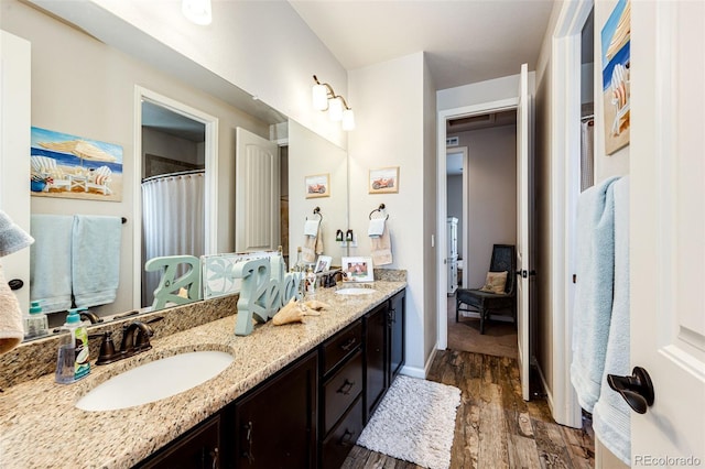 2115 Holmby Ct, Castle Rock, CO 80104 - full bath featuring wood finished floors and double vanity