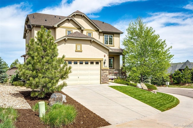 2115 Holmby Ct, Castle Rock, CO 80104 - view of front facade with stucco siding, concrete driveway, covered porch, and stone siding